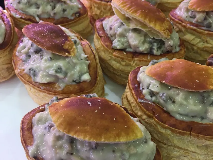 Puff-pastry cases filled with veal sweetbreads and morels, their golden lids set on top.